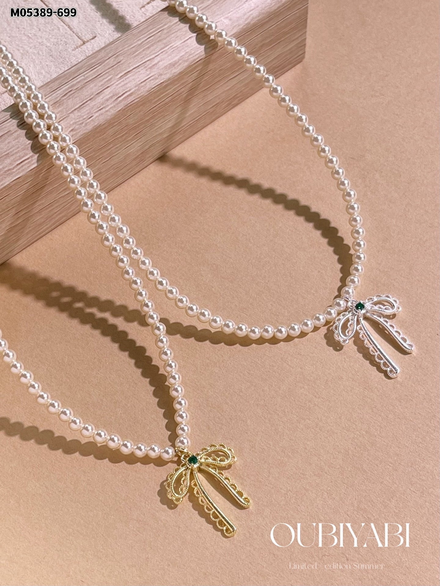 Elegant pearl design with a gold bowknot