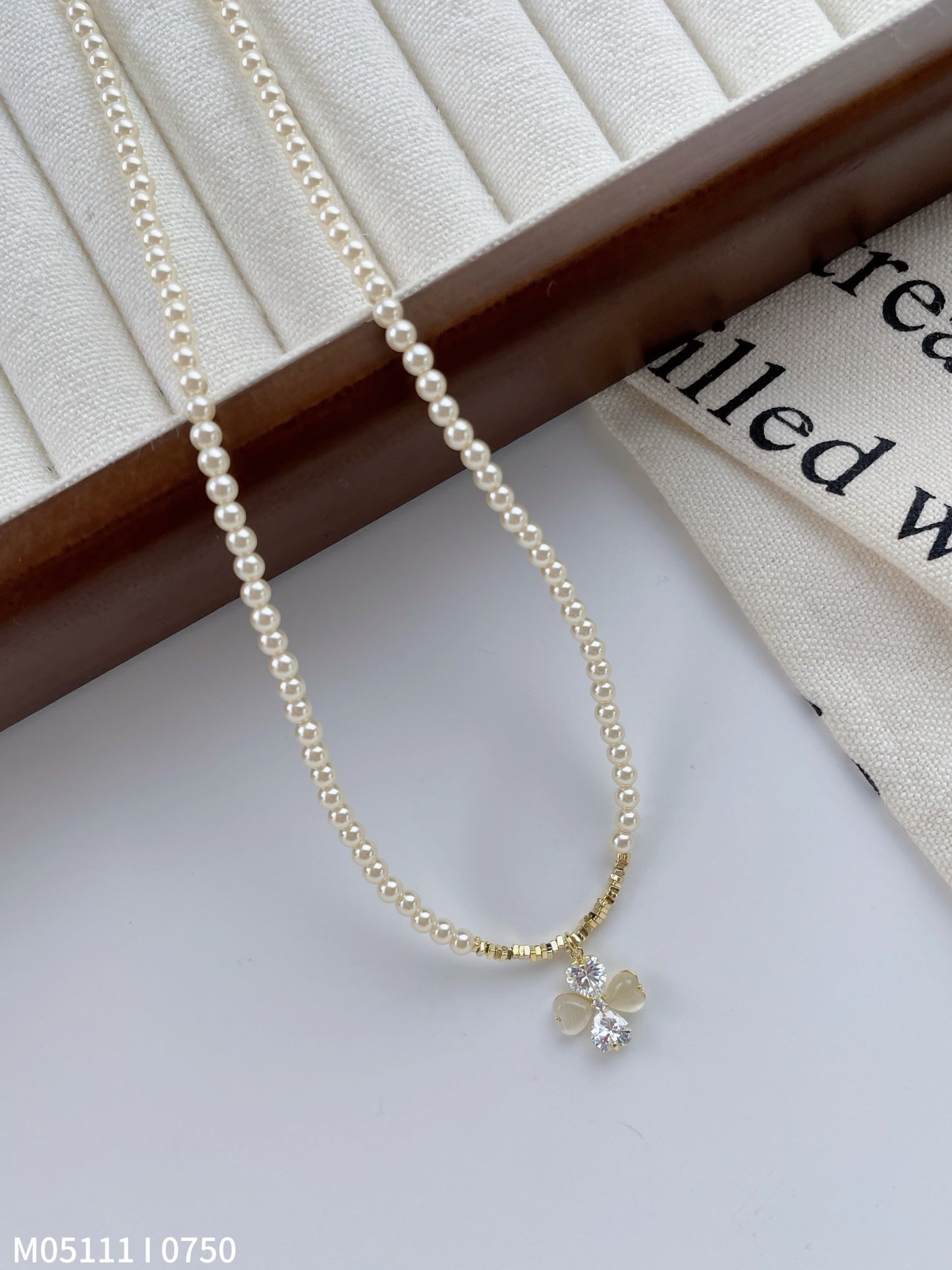 Women's pearl necklace with bow charm