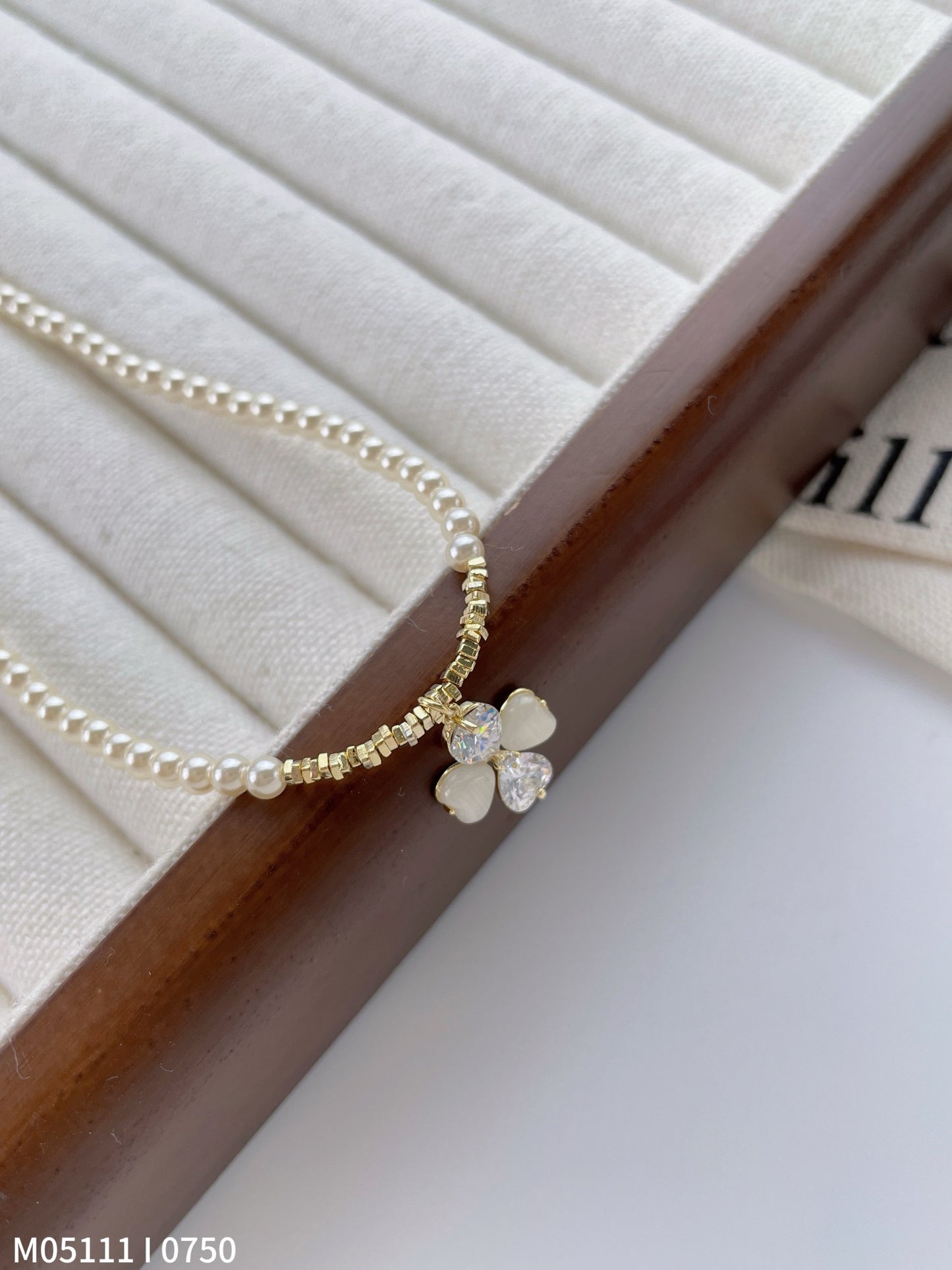 Women's pearl necklace with bow charm