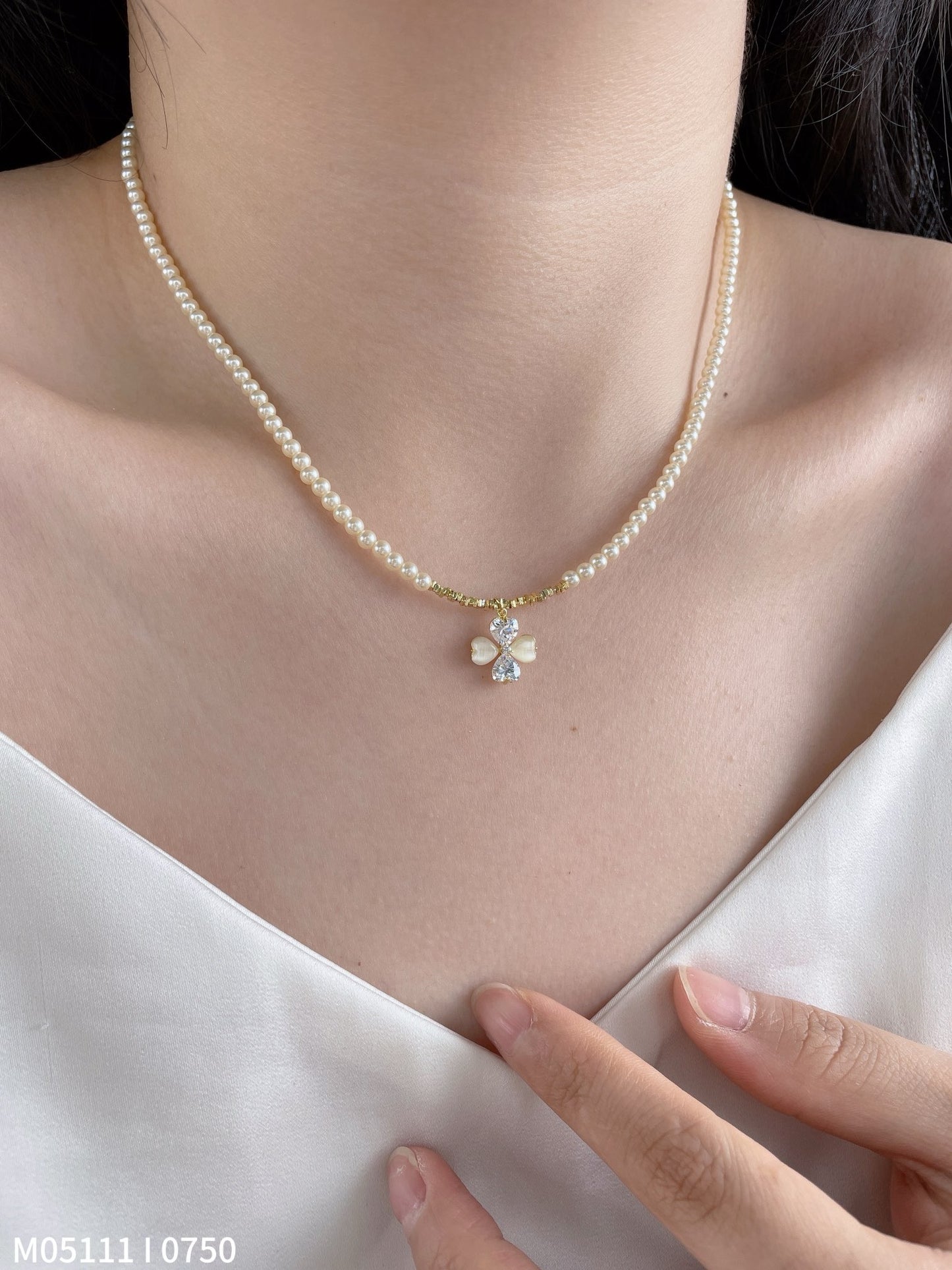 Women's pearl necklace with bow charm
