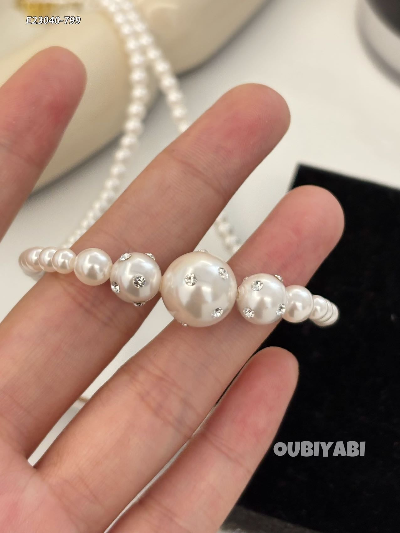 White pearl necklace worn with black dress