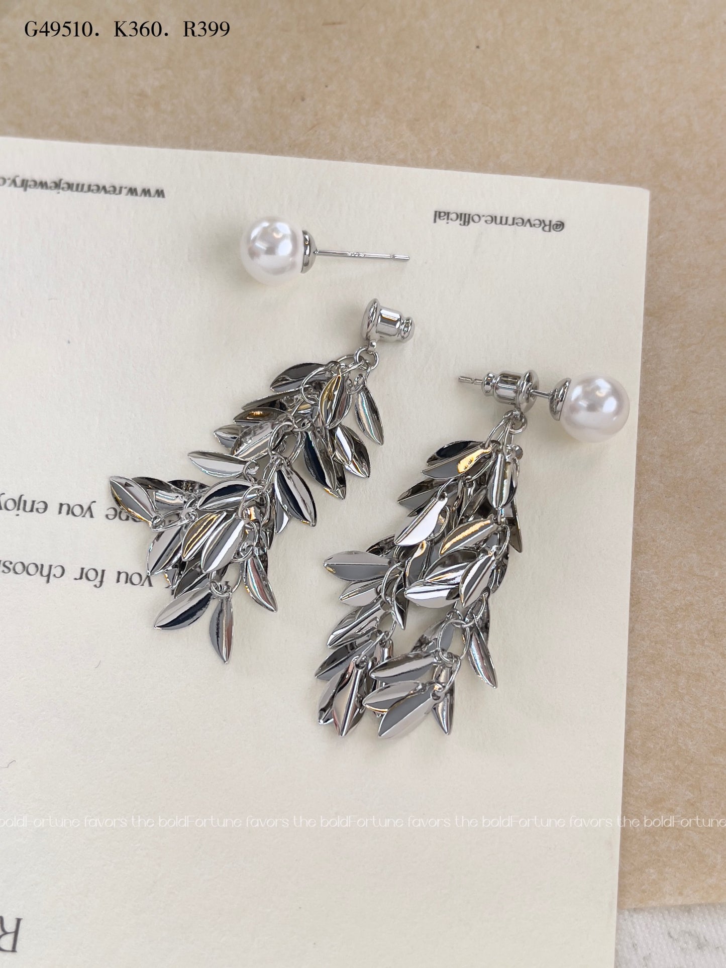 Shiny silver drop earrings with botanical leaf design