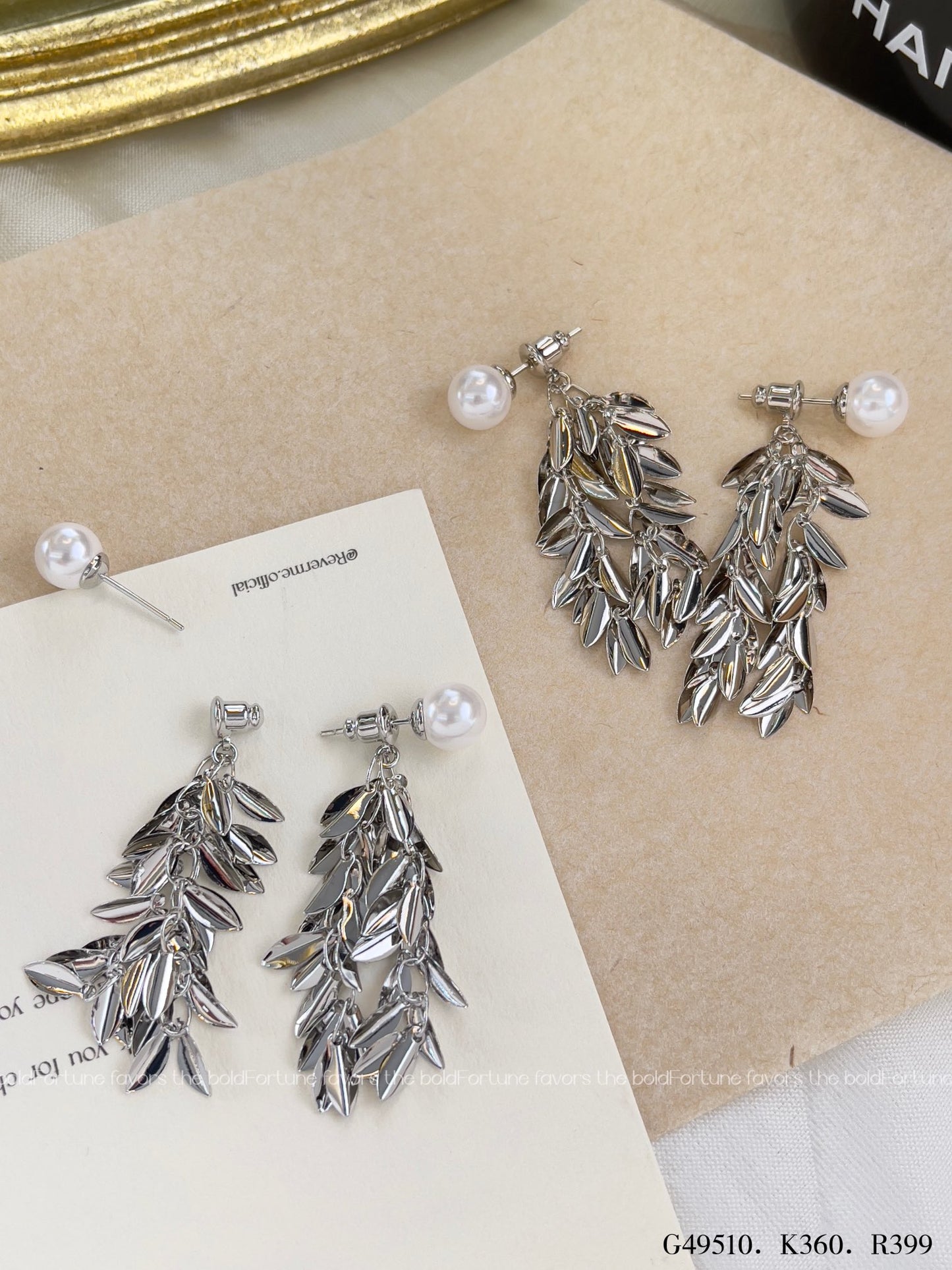 Shiny silver drop earrings with botanical leaf design