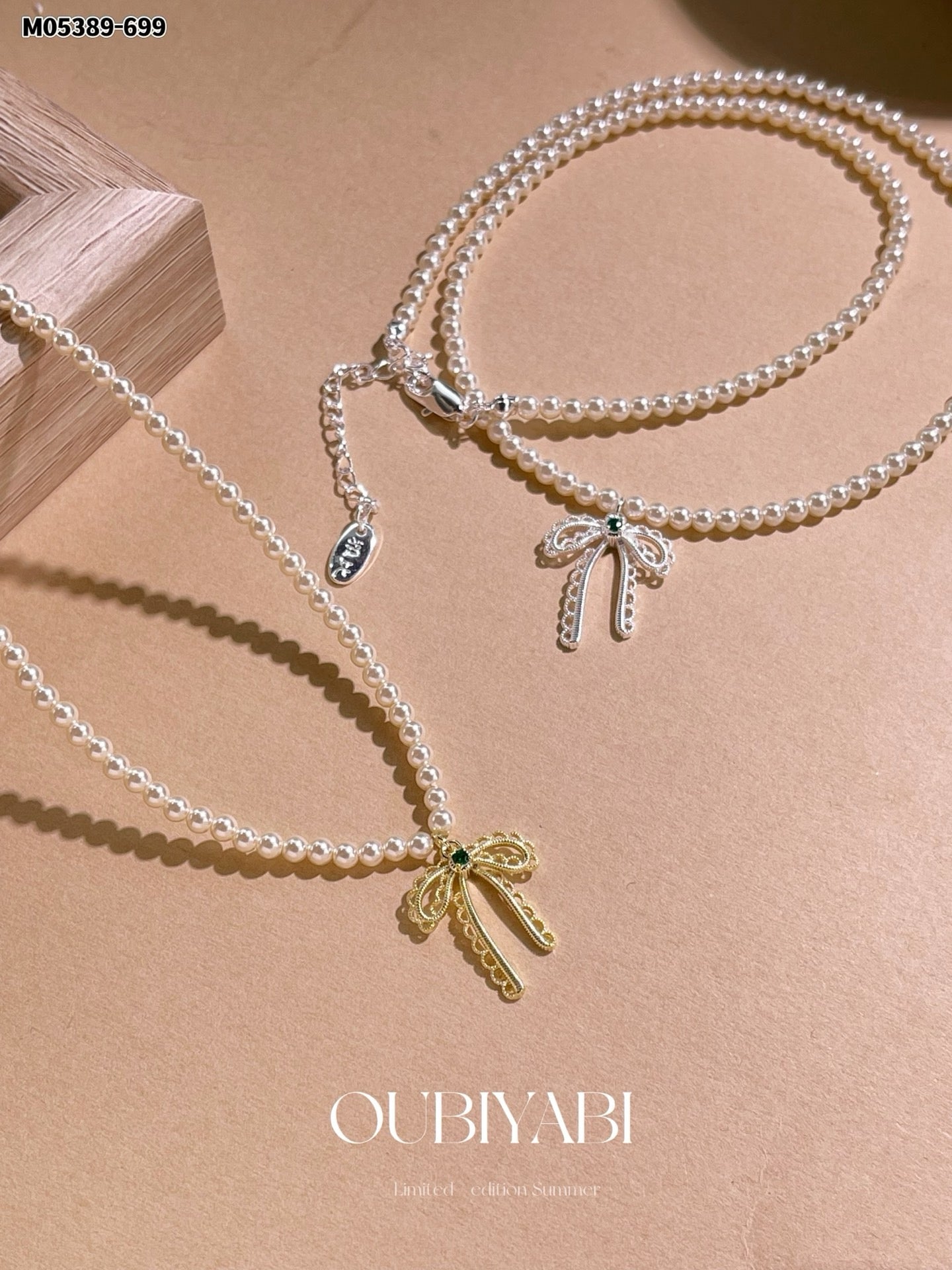 Elegant pearl design with a gold bowknot