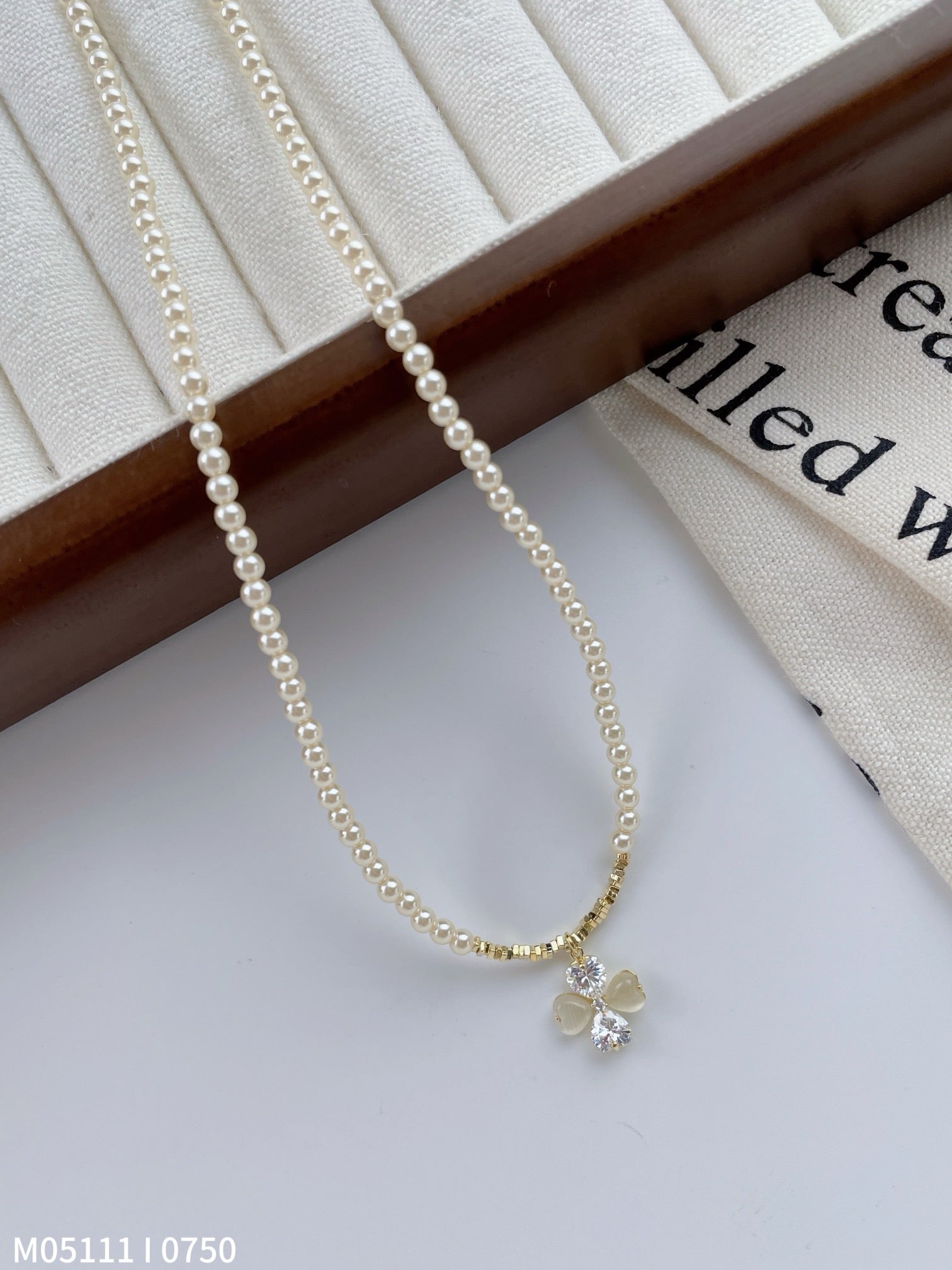 Women's pearl necklace with bow charm