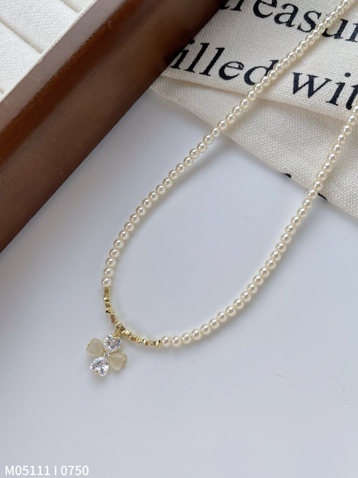 Women's pearl necklace with bow charm