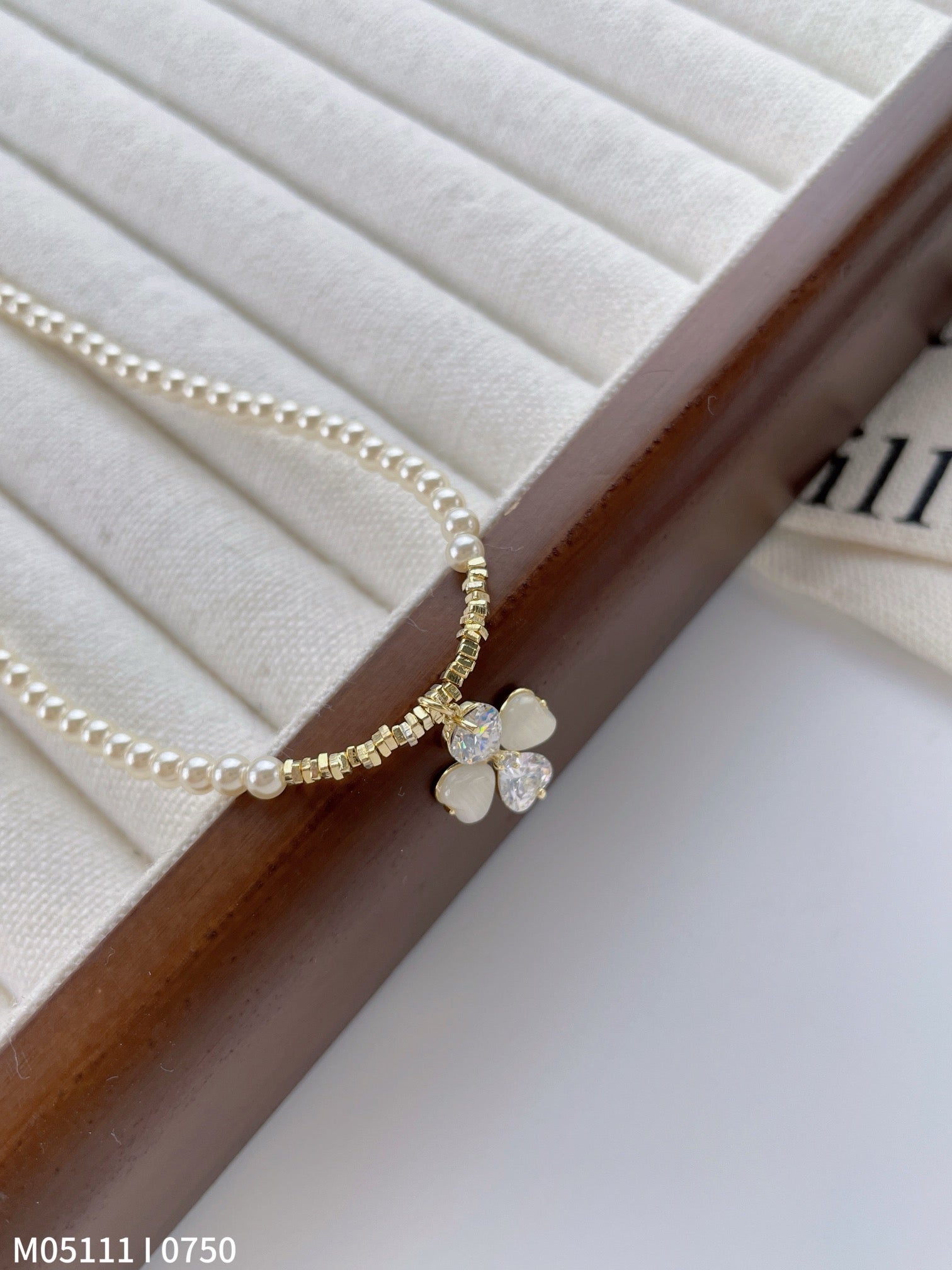 Women's pearl necklace with bow charm