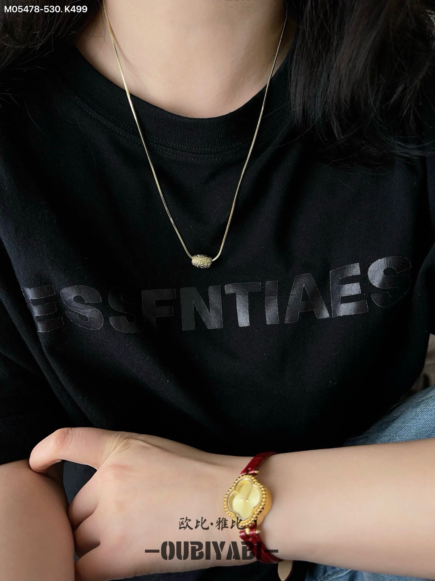 Two-tone metal necklace with silver and gold chains and a carved pendant.