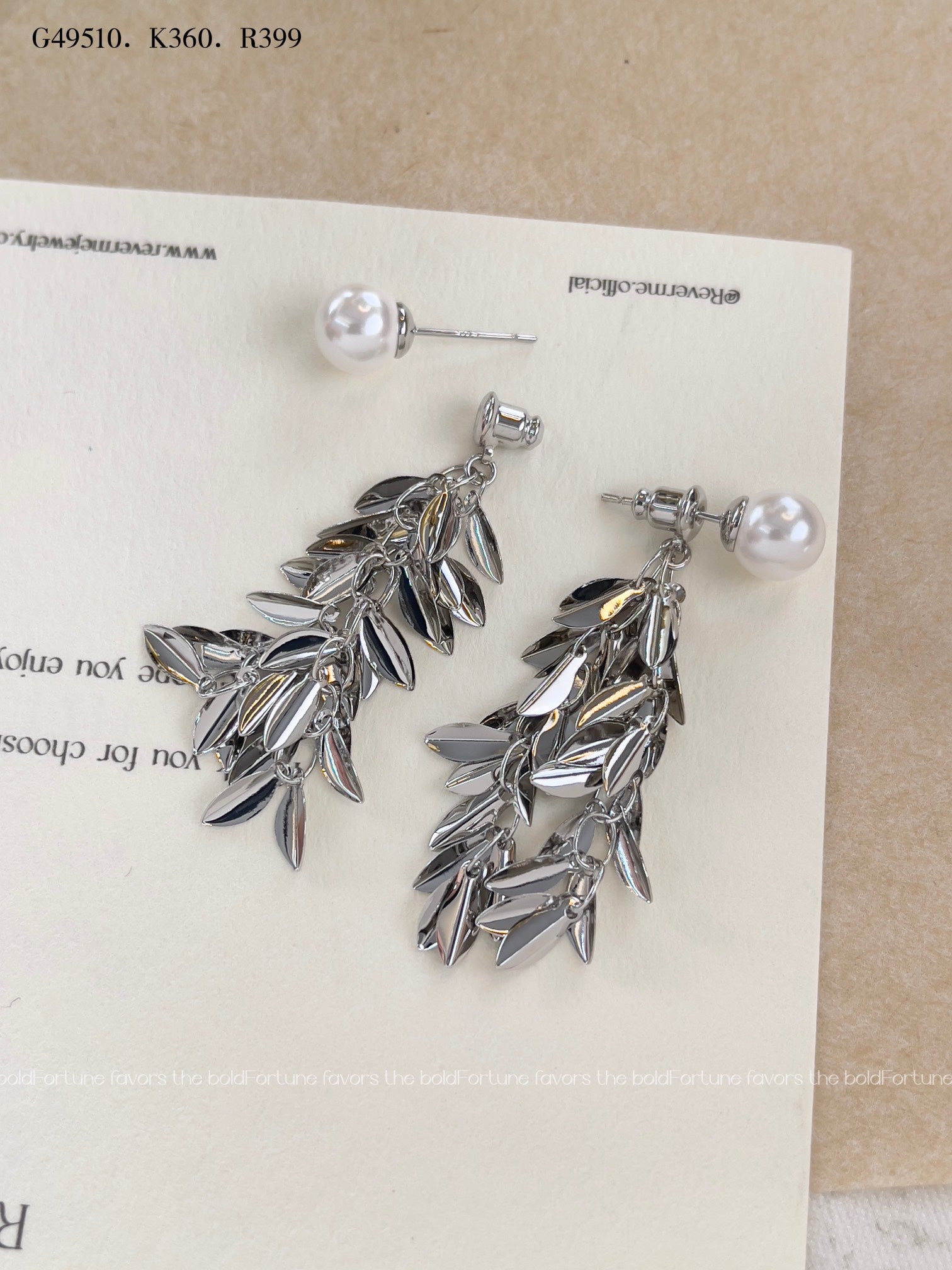 Shiny silver drop earrings with botanical leaf design