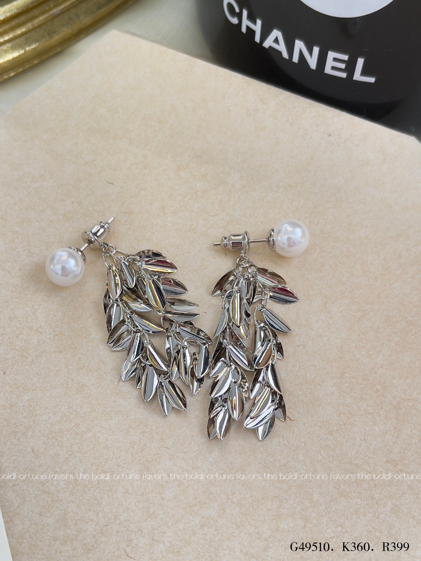 Shiny silver drop earrings with botanical leaf design