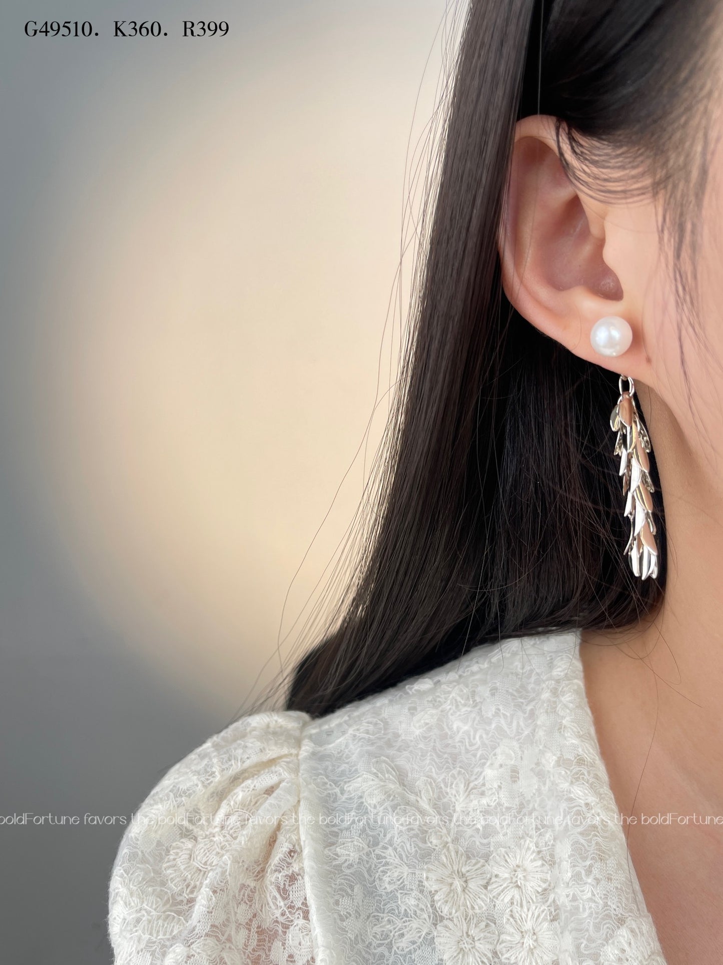 Shiny silver drop earrings with botanical leaf design